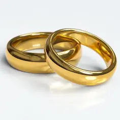 Dwa złote pierścionki, próba 585, symbolizujące wieczną miłość i wspólne życie.